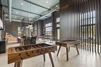 Gaming lounge with billiards, foosball, shuffleboard, and vintage arcade games